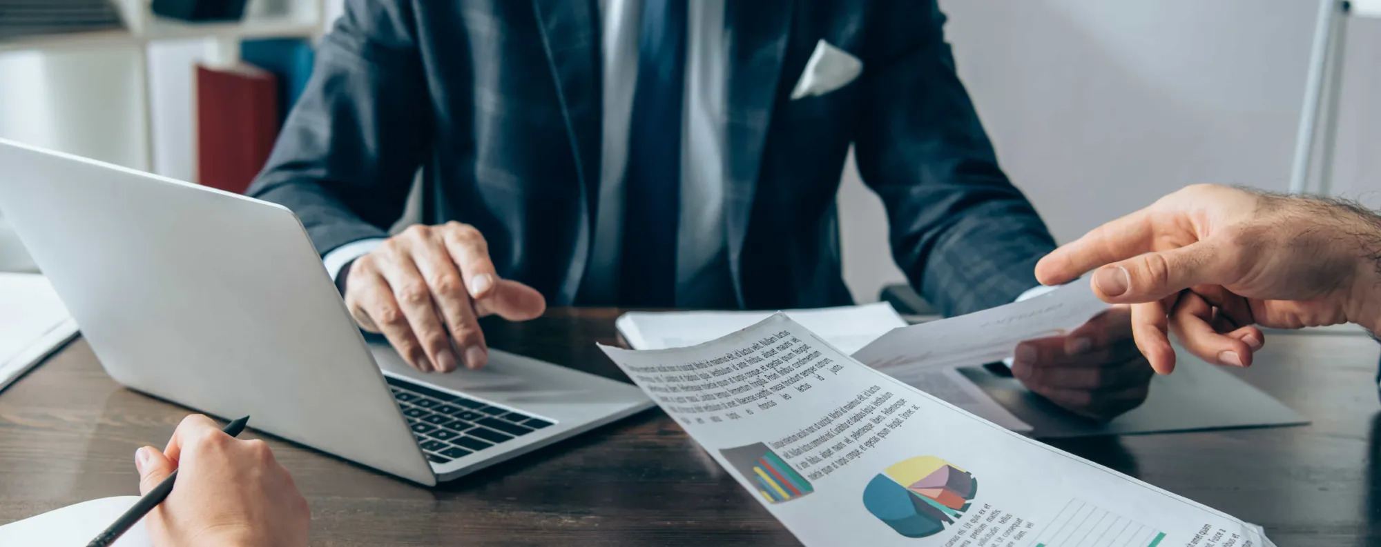 Person working on computer at desk.
