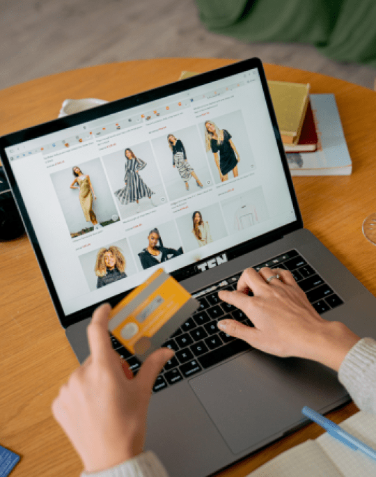 Someone looking at dress options on a website using their laptop