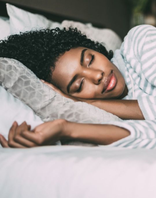 Woman sleeping in bed.
