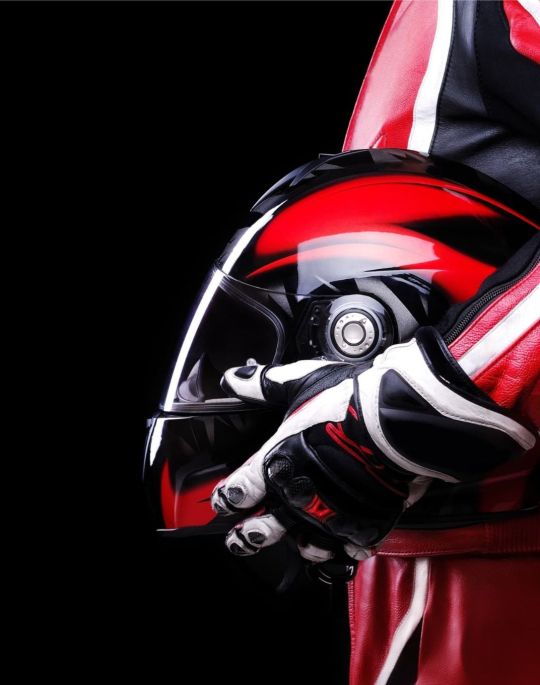 Person wearing red motorcycle riding gear.