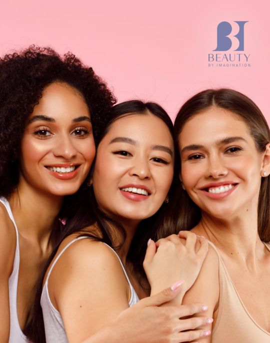 Three women posing for photo with BBI logo on the top right corner