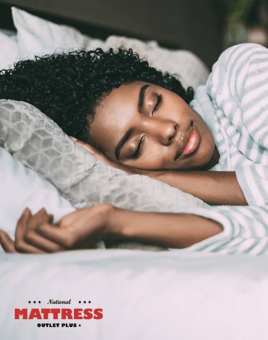 Woman sleeping in bed with National Mattress logo overlay